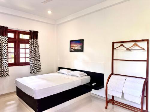 a bedroom with a bed and a window at Jungle Fence in Bentota