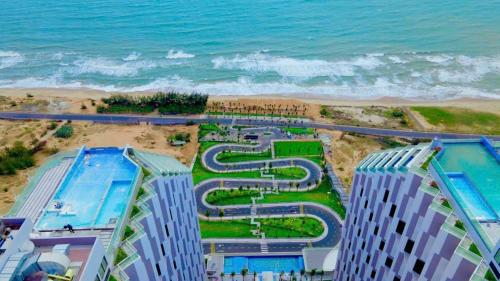 an aerial view of a resort by the beach at Bstudio in APEC Mandala Mũi Né in Phan Thiet