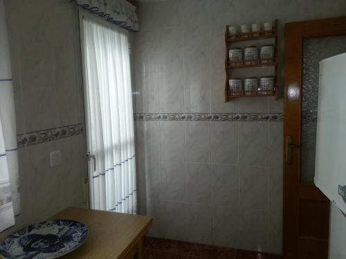 a small kitchen with a table and a window at Residence Lucia B&B in Guardamar del Segura