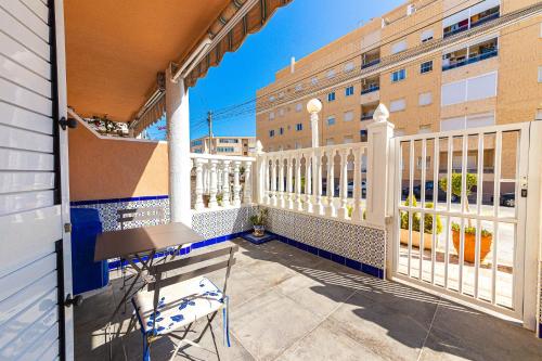 a balcony with a table and chairs and a building at Puerto Romano 21 in La Mata