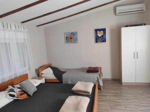 a bedroom with two beds and a closet at Villa SUNFLOWER in Mostar