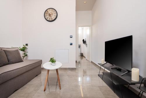 a living room with a couch and a tv at Magical Brand New Suite in Zipárion