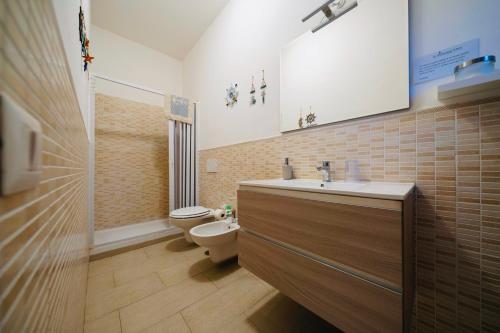 a bathroom with a sink and a toilet at Il Poggetto di Porto Ercole in Porto Ercole