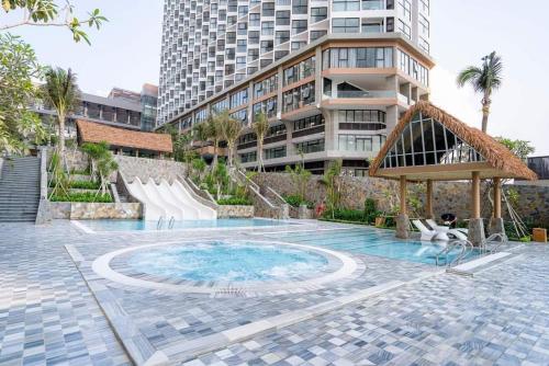 a swimming pool with a slide in a building at Bstudio in APEC Mandala Mũi Né in Phan Thiet