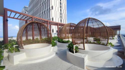 two bird cages with plants in them on a building at Bstudio in APEC Mandala Mũi Né in Phan Thiet