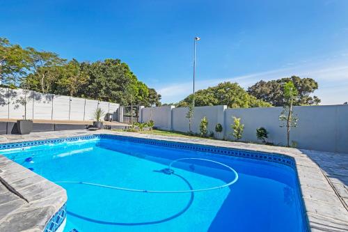 a swimming pool in the backyard of a house at Mountain View Villa in Cape Town