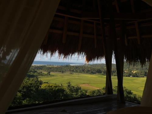 a room with a view of a field from a window at SumbaFarmHouse in Patiala Bawa