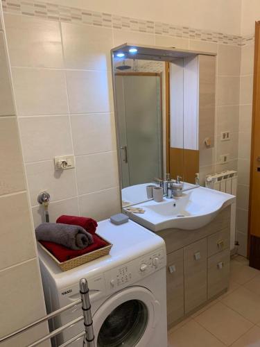 a bathroom with a washing machine and a sink at House 417 Perugia in Perugia