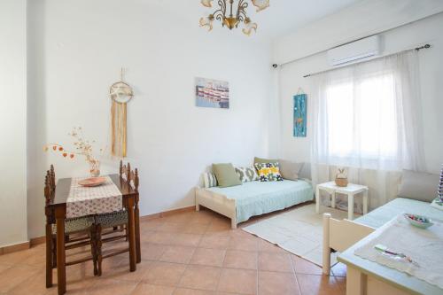 a living room with a couch and a table at Passiflora Vacation House in Nydri