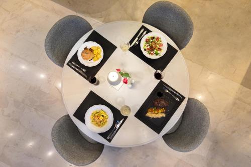 a round table with plates of food on it at Brasil Suites Boutique Hotel in Athens