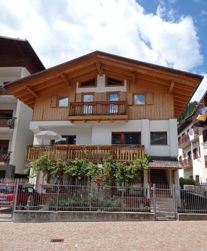 an apartment building with a balcony on top of it at ROOM AURORA in Fiera di Primiero