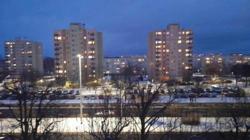 a city skyline with tall buildings and a parking lot at Mieszkanie osiedle Północ Zameldowanie 24h in Koszalin