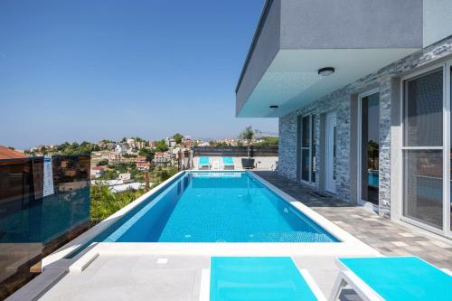 uma piscina no telhado de uma casa em Villa Ivka - Apartment Oliva & Studio apartment Deluxe em Podstrana