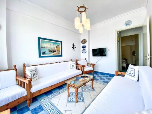 a living room with two couches and a table at Korali SeaView Apartment, Perea in Perea