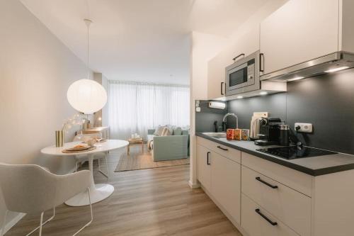 a kitchen with a counter and a table in a room at Central Apartment near Opera - 1 Room in Bayreuth