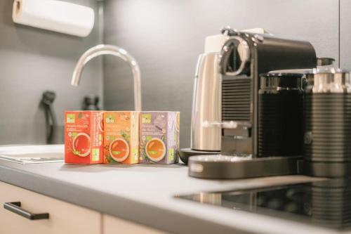 a kitchen counter with a coffee maker next to a sink at Central Apartment near Opera - 1 Room in Bayreuth