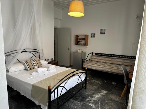 Postel nebo postele na pokoji v ubytování KIRIKOS ROOMS