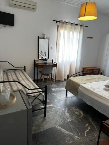 Postel nebo postele na pokoji v ubytování KIRIKOS ROOMS
