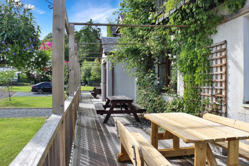 a picnic table and bench outside of a building at Lodges by Atholl Palace in Pitlochry