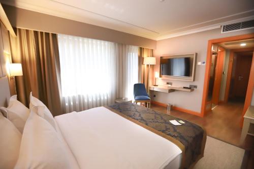 a hotel room with a bed and a television at La Quinta by Wyndham Giresun in Giresun