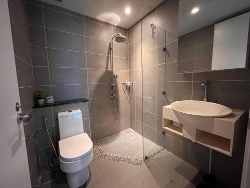 a bathroom with a shower and a toilet and a sink at Riverson SOHO Kota Kinabalu in Kota Kinabalu