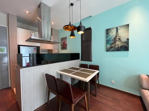 a dining room with a table and chairs and the eiffel tower at Riverson SOHO Kota Kinabalu in Kota Kinabalu