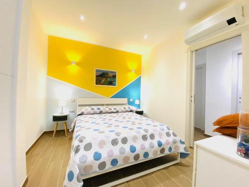 a bedroom with a bed and a yellow wall at Casa Mora in San Vero Milis