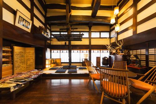 a large room with chairs and a table with food at Ryokan Asunaro in Takayama