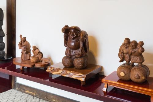 a group of wooden figurines sitting on a table at Ryokan Asunaro in Takayama