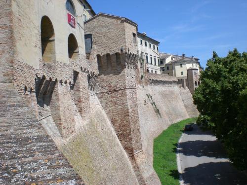 a large brick wall next to a building at La Dimora del Centro in Iesi