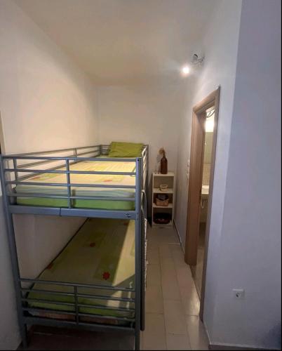 a room with two bunk beds and a hallway at Glifa Beach House Maisonette in Glida