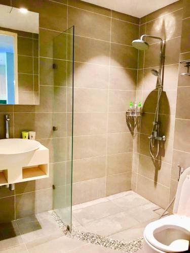 a bathroom with a shower and a toilet and a sink at Riverson SOHO Kota Kinabalu in Kota Kinabalu