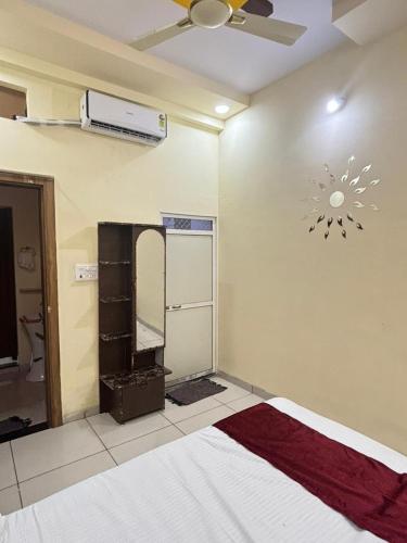 a bedroom with a bed and a ceiling fan at Dream Ashoka in Ujjain