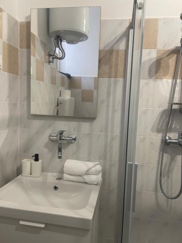 a bathroom with a sink and a shower at Retreat Apartments with free parking in Pula