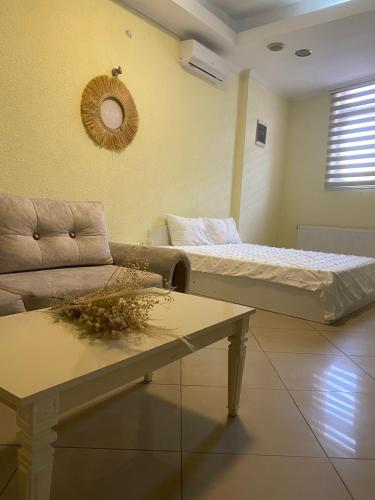 a living room with a bed and a couch at Zezo Apartments in Bitola