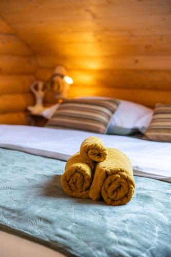 a monkey cookie sitting on top of a bed at Kuća DORINE in Fužine