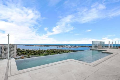 a swimming pool on the roof of a building at Sweeping Ocean view Apt w Carpark and rooftop pool in Gold Coast