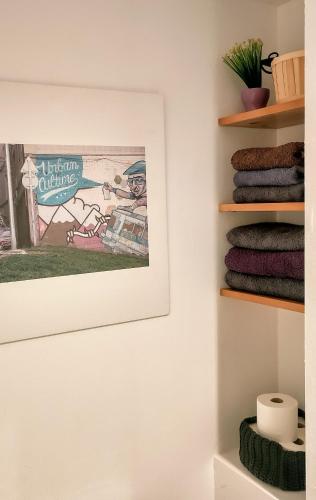 a picture hanging on a wall with towels at Apartament a Mas l'Erm in Girona