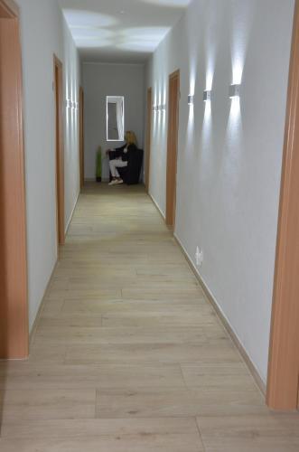a hallway of an office with a woman sitting on a couch at Hotel Zum Seemann in Cuxhaven