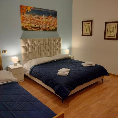 a bedroom with a large bed with two towels on it at Hotel Alba Serravalle in Serravalle Pistoiese