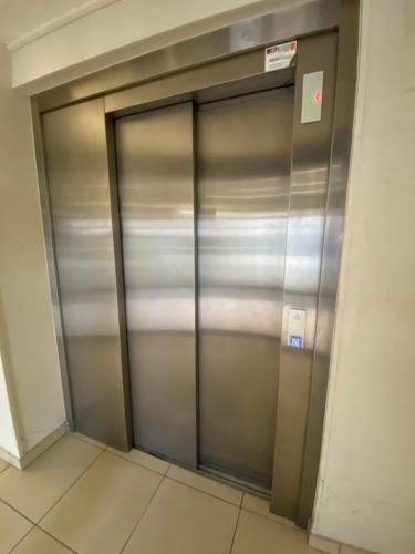 a metal elevator door in a building at Evasion verdoyante à Disney in Bussy-Saint-Georges