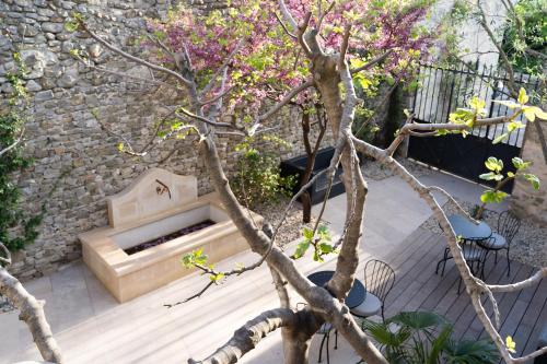 a garden with a stone fireplace and a tree at La Barule in Charols