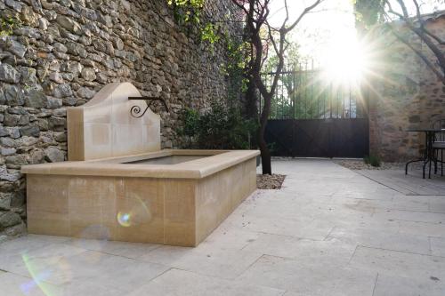 a stone bench sitting in front of a stone wall at La Barule in Charols