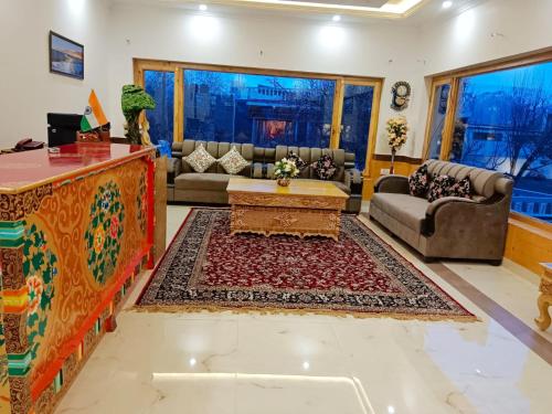 a living room with a couch and a table at Kidar in Leh
