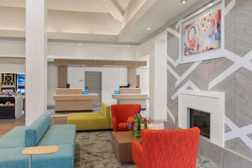 a lobby with two chairs and a fireplace at Hilton Garden Inn Atlanta East/Stonecrest in Lithonia