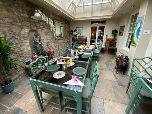 a dining room with long tables and chairs at The Casterbridge in Dorchester