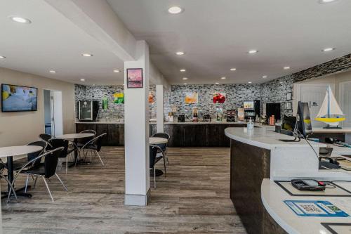 a restaurant with tables and chairs and a counter at Quality Inn Rockport on Aransas Bay in Rockport