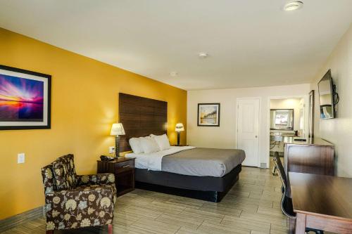 a hotel room with a bed and a chair at Quality Inn Rockport on Aransas Bay in Rockport