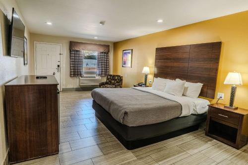 a hotel room with a large bed and a desk at Quality Inn Rockport on Aransas Bay in Rockport