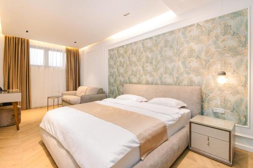 a bedroom with a large bed and a wall mural at Miramar in Ulcinj